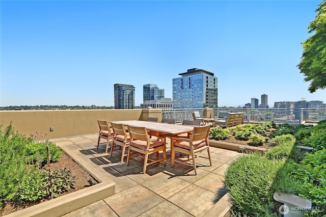 view of patio / terrace with a view of city and outdoor dining area