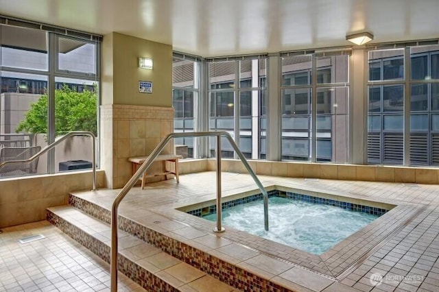 view of swimming pool featuring an indoor hot tub