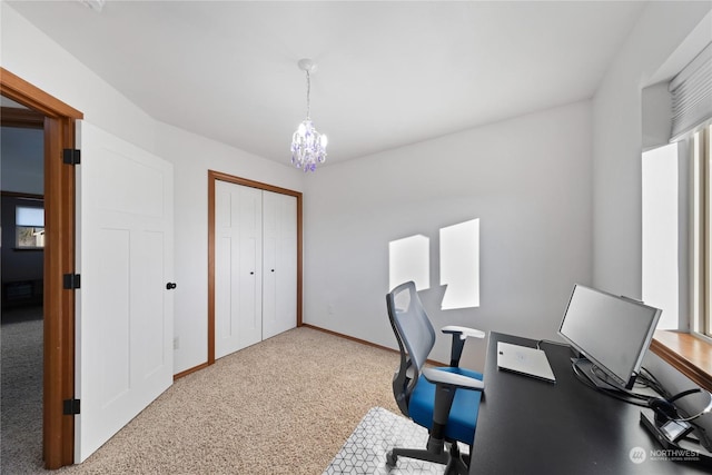 carpeted office space with an inviting chandelier and baseboards