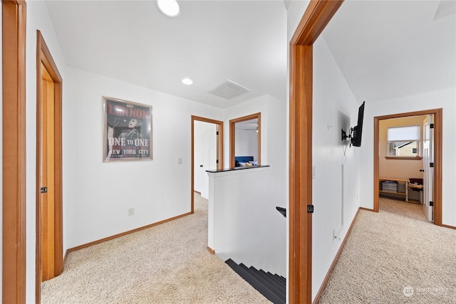 hallway with visible vents, recessed lighting, carpet, and baseboards