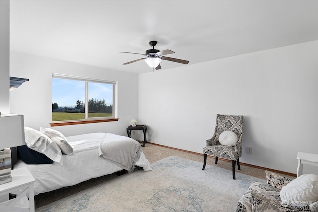 bedroom with ceiling fan and light carpet