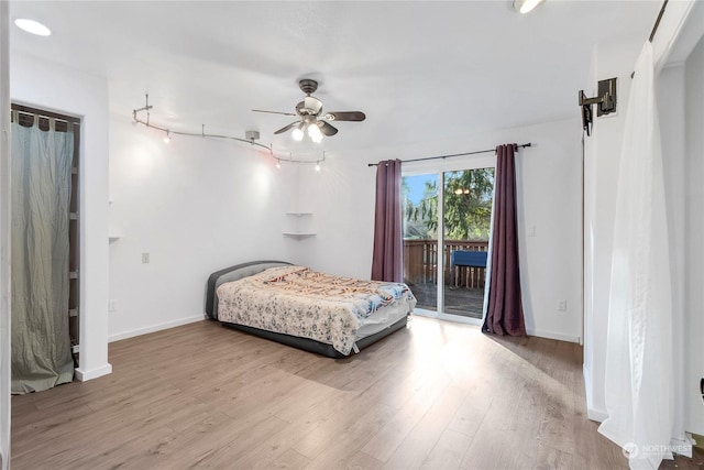 bedroom with ceiling fan, access to exterior, and light hardwood / wood-style floors