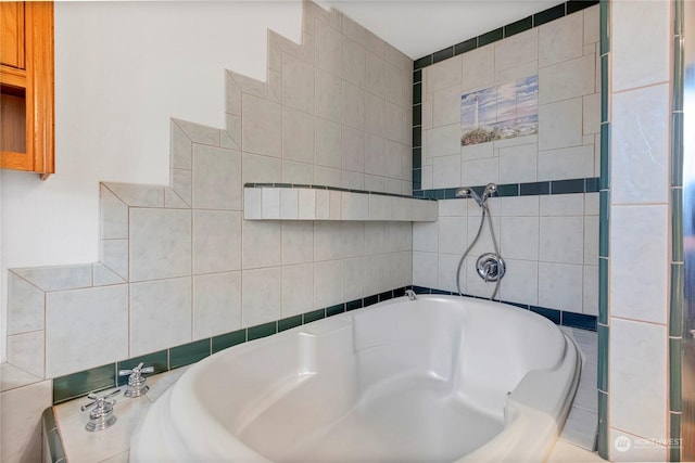 bathroom featuring a washtub and tile walls