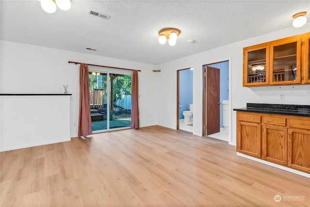 interior space with light hardwood / wood-style flooring and a textured ceiling