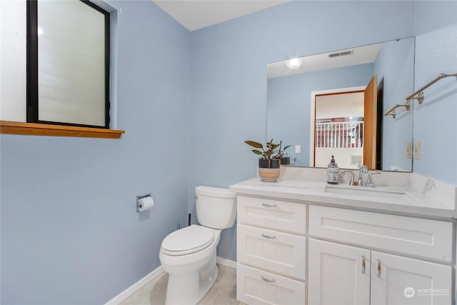 bathroom with vanity, tile patterned floors, and toilet