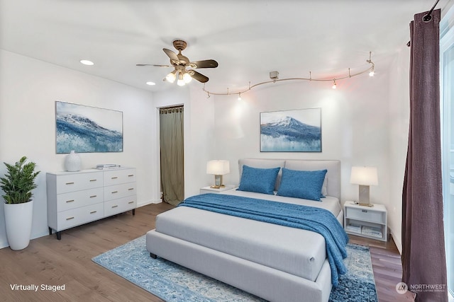 bedroom featuring ceiling fan and light hardwood / wood-style floors