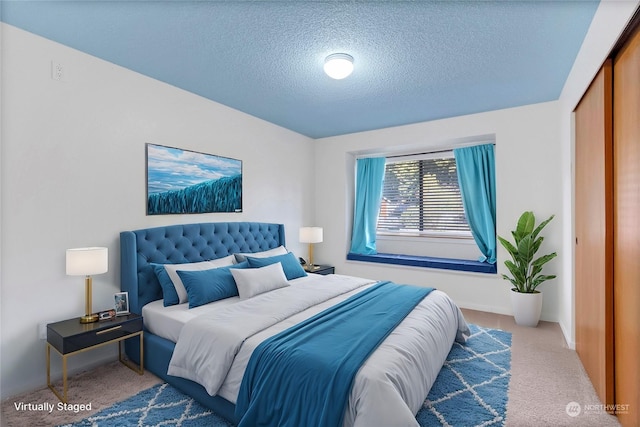 carpeted bedroom featuring a textured ceiling