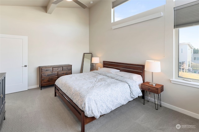 carpeted bedroom with beamed ceiling