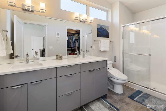 bathroom with vanity, an enclosed shower, and toilet