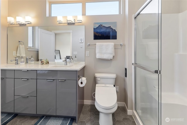 bathroom with tile patterned floors, vanity, toilet, and an enclosed shower