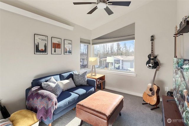 living room with ceiling fan and dark colored carpet