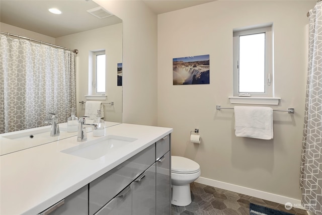 bathroom with vanity and toilet