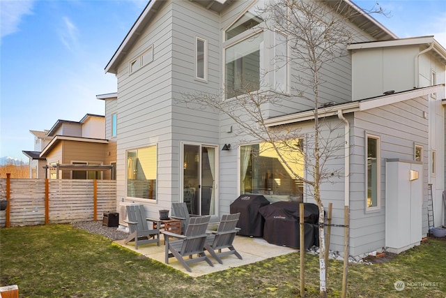 rear view of property with a patio and a yard