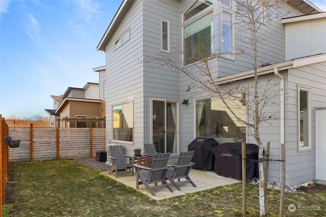 rear view of property featuring a yard and a patio area