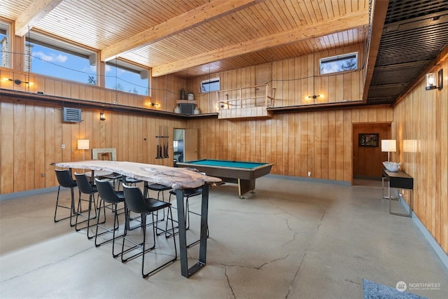 game room featuring a towering ceiling, beam ceiling, and wood walls