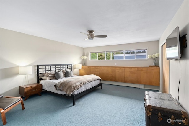 carpeted bedroom featuring multiple windows, ceiling fan, and baseboard heating