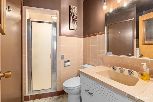 bathroom with walk in shower, vanity, toilet, and tile walls