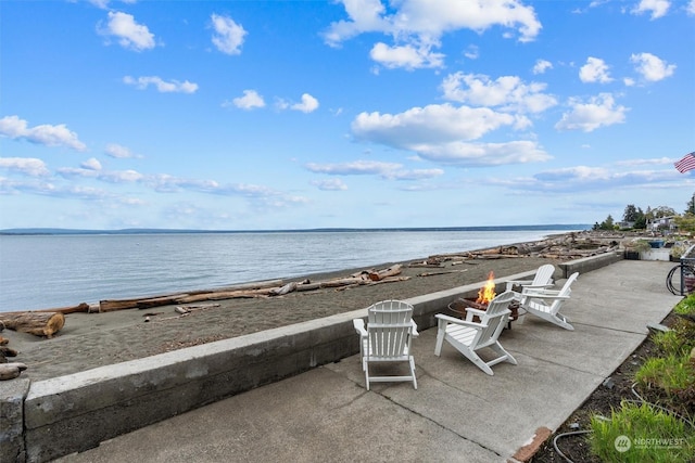 view of water feature with a fire pit