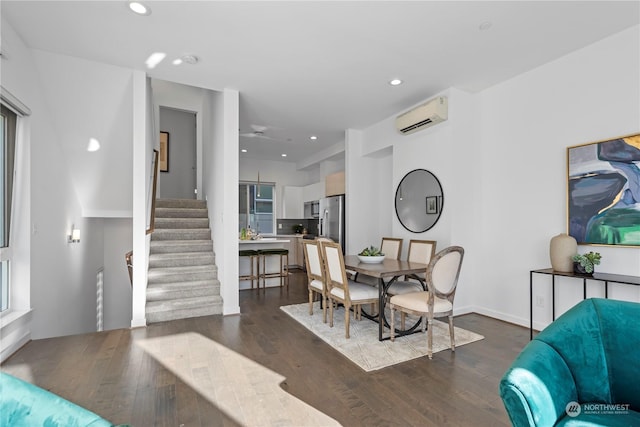 dining area featuring dark hardwood / wood-style floors and an AC wall unit