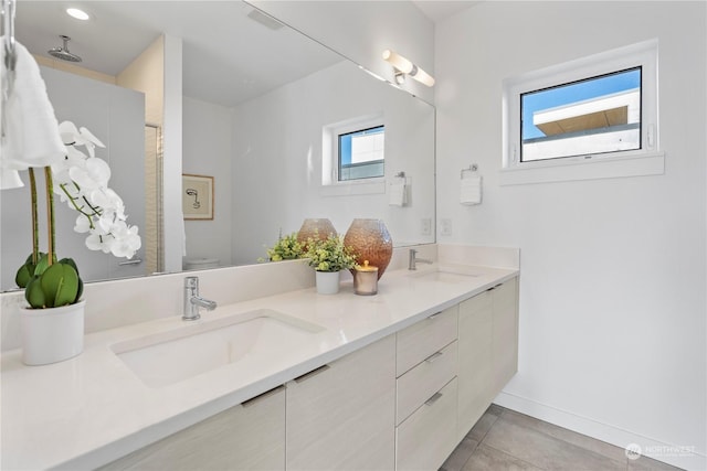 bathroom with tile patterned floors, vanity, and toilet