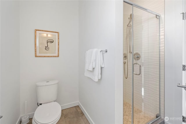 bathroom featuring tile patterned floors, toilet, and an enclosed shower