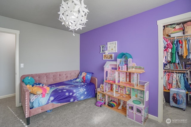 bedroom featuring a chandelier, light carpet, and a closet