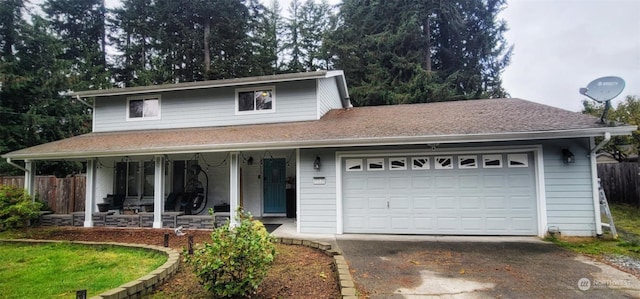 front facade featuring a garage and covered porch