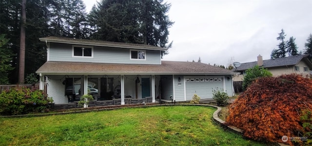 view of front property with a garage, covered porch, and a front lawn