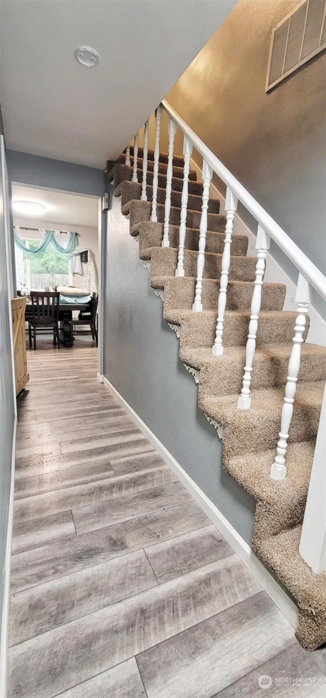 stairway featuring hardwood / wood-style flooring