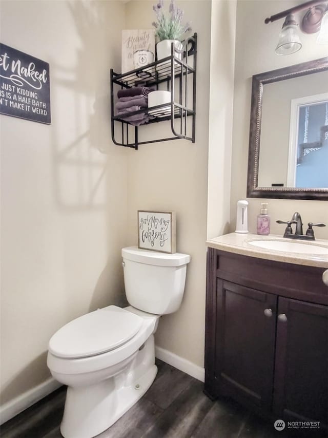 bathroom featuring vanity, hardwood / wood-style floors, and toilet