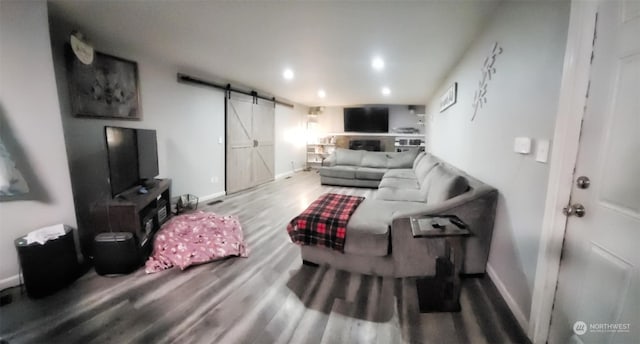 living room with hardwood / wood-style flooring and a barn door