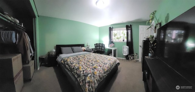 carpeted bedroom with lofted ceiling