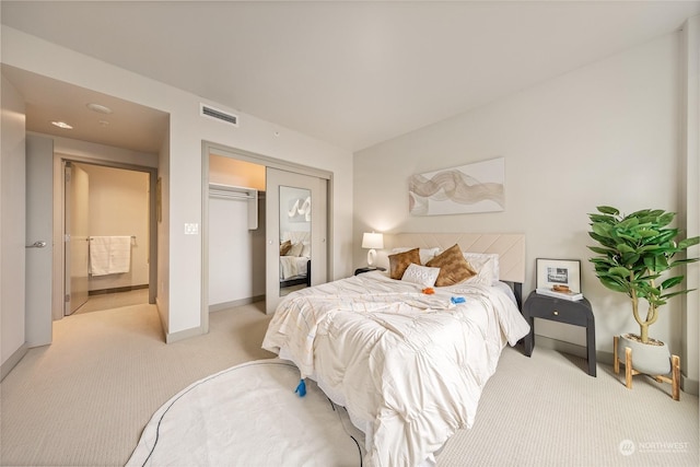 bedroom featuring light carpet and a closet