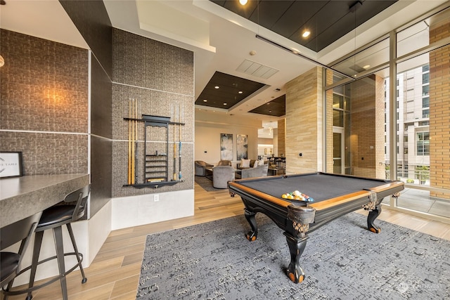 recreation room featuring a towering ceiling and pool table