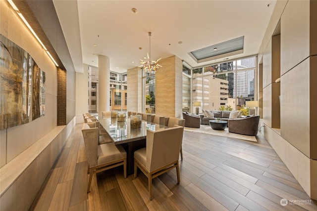 dining area featuring an inviting chandelier and light hardwood / wood-style flooring