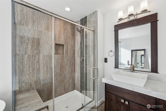 bathroom featuring vanity and an enclosed shower