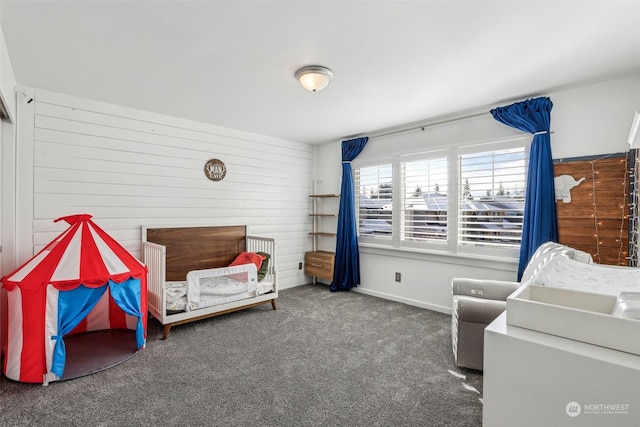 carpeted bedroom with wooden walls