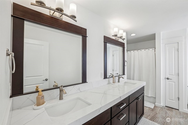 bathroom featuring vanity and curtained shower