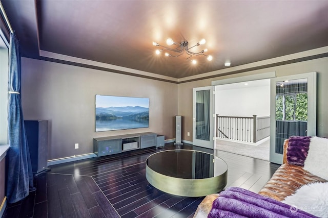 living room with a tray ceiling and hardwood / wood-style flooring