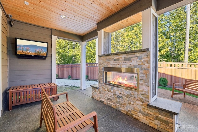 view of patio / terrace featuring an outdoor stone fireplace