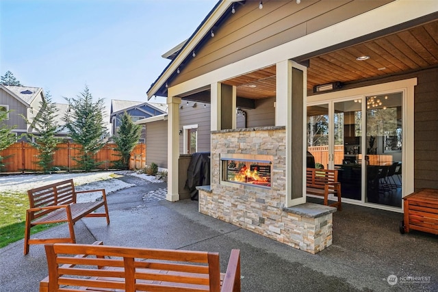 view of patio / terrace featuring an outdoor stone fireplace