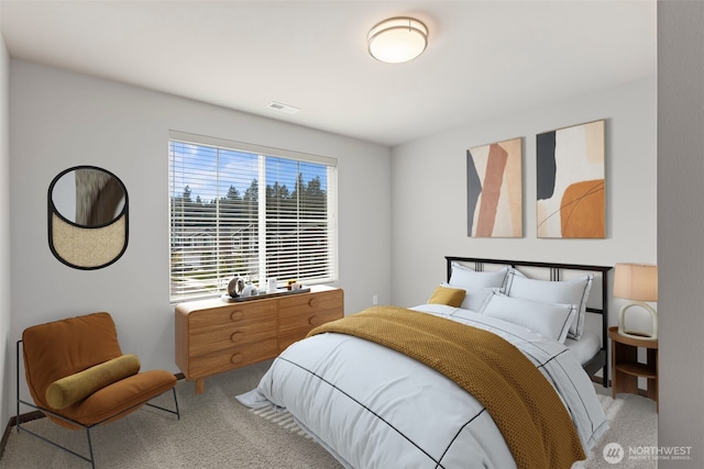 bedroom featuring light colored carpet and visible vents