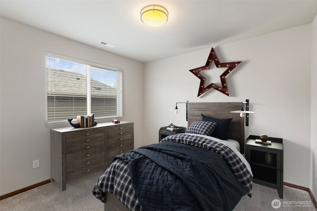 bedroom featuring carpet floors, visible vents, and baseboards