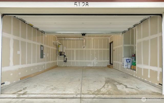 garage featuring electric panel and a garage door opener