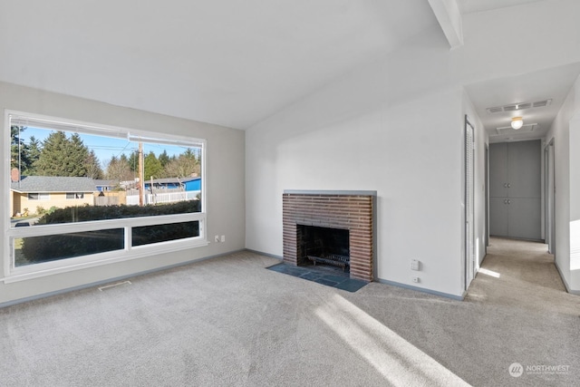 unfurnished living room featuring light carpet, vaulted ceiling with beams, and a fireplace