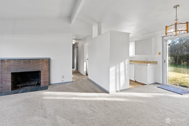 unfurnished living room with light colored carpet, a healthy amount of sunlight, and a fireplace