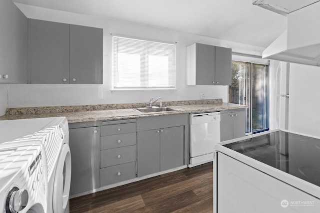 kitchen with sink, gray cabinetry, dark hardwood / wood-style floors, white appliances, and washer / clothes dryer