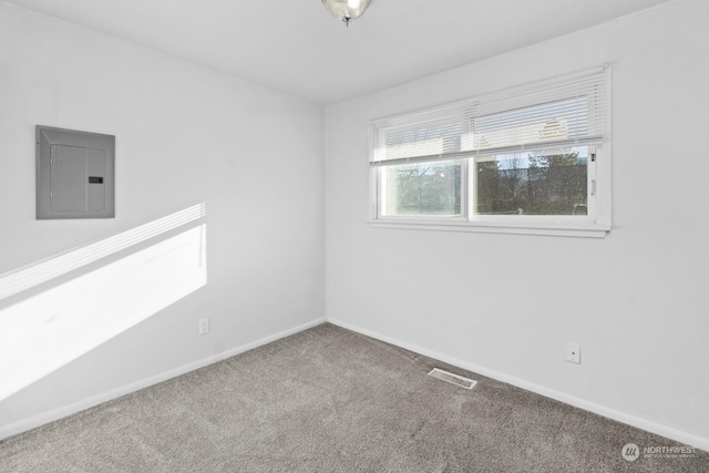 carpeted empty room with electric panel