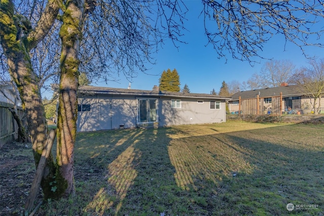 back of house with a lawn