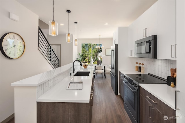 kitchen featuring sink, high end fridge, dark brown cabinets, range with electric stovetop, and white cabinets